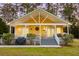 Quaint cottage with a front porch, showcasing the cozy ambiance and inviting curb appeal of this lovely home at 104 Gervais St, Walterboro, SC 29488