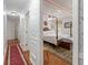 Hallway looking into bedroom with four poster bed and seating area at 104 Gervais St, Walterboro, SC 29488
