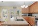 Well-equipped kitchen features a center island with sink, stainless steel appliances and plenty of sunlight at 104 Gervais St, Walterboro, SC 29488