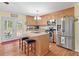 Modern kitchen with stainless steel appliances, center island, and backyard access at 104 Gervais St, Walterboro, SC 29488