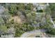 Aerial view of the property featuring tree coverage and building with tennis court at 104 Gervais St, Walterboro, SC 29488