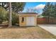 Backyard shed with white doors and a window for natural light at 104 Gervais St, Walterboro, SC 29488