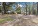 Large yard with mature trees surrounding the home, providing privacy and natural beauty at 104 Gervais St, Walterboro, SC 29488