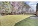 View of a large backyard with a lush lawn and wood fence at 107 Four Iron Dr, Summerville, SC 29483