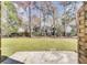 A large backyard with a concrete patio and a wood fence at 107 Four Iron Dr, Summerville, SC 29483