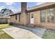 The backyard features a concrete patio and brick exterior at 107 Four Iron Dr, Summerville, SC 29483