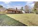 A large backyard with a lush lawn, wood fence, and the house exterior at 107 Four Iron Dr, Summerville, SC 29483