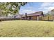 Wide view of the backyard showcasing the lawn and house exterior at 107 Four Iron Dr, Summerville, SC 29483