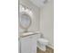Traditional bathroom with decorative mirror, granite counters, and white cabinets at 107 Four Iron Dr, Summerville, SC 29483