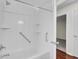 White bathroom features a shower/tub, grab bars, and a view to a bedroom at 107 Four Iron Dr, Summerville, SC 29483