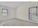 Light-filled bedroom featuring a vaulted ceiling and two large windows at 107 Four Iron Dr, Summerville, SC 29483