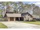 Charming home featuring a brick and wood exterior with a well-manicured lawn and an attached garage at 107 Four Iron Dr, Summerville, SC 29483