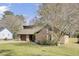 Charming home featuring a brick and wood exterior with a well-manicured lawn and an attached garage at 107 Four Iron Dr, Summerville, SC 29483