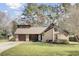 Charming home featuring a brick and wood exterior with a well-manicured lawn and an attached garage at 107 Four Iron Dr, Summerville, SC 29483