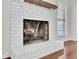 Painted brick fireplace with wooden mantle provides a cozy focal point in the room at 107 Four Iron Dr, Summerville, SC 29483