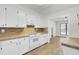Well-lit kitchen featuring white cabinets, matching appliances, and tile countertops at 107 Four Iron Dr, Summerville, SC 29483