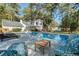 A refreshing in-ground pool surrounded by lounge chairs, with lush landscaping, and a well-maintained lawn at 107 President Cir, Summerville, SC 29483