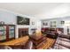 Inviting living room with a fireplace, mounted TV, and comfortable leather seating at 107 President Cir, Summerville, SC 29483