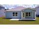 A beautiful single-story home with a covered patio and a well-maintained lawn, perfect for outdoor relaxation and entertainment at 116 Royal Cainhoy Way, Huger, SC 29450