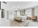 Spacious main bedroom featuring a ceiling fan, a walk-in closet, bench, and ample natural light at 1161 Triple Crown Ct, Mount Pleasant, SC 29429