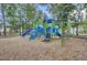 A blue and green playground with slides, stairs, and a climbing net surrounded by trees in a Gathering-friendly community at 1161 Triple Crown Ct, Mount Pleasant, SC 29429