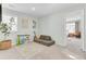 Bright playroom offers plenty of space for activities, featuring natural light and doorway to a bedroom at 1161 Triple Crown Ct, Mount Pleasant, SC 29429