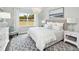 Serene bedroom with a large window, neutral colors, soft bedding, and elegant lighting at 118 Royal Cainhoy Way, Huger, SC 29450
