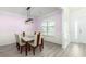 Dining room with modern light fixture and large window, complementing the sleek table and chair set at 126 Lakelyn Rd, Moncks Corner, SC 29461