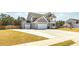 View of the home featuring a spacious driveway, a 2 car garage, and a well manicured lawn at 126 Lakelyn Rd, Moncks Corner, SC 29461