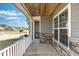 Inviting covered porch featuring stone accents and a view of the neighborhood at 126 Lakelyn Rd, Moncks Corner, SC 29461