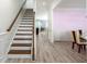 Open staircase with wood steps and railing leading to the upper level and adjoining dining room at 126 Lakelyn Rd, Moncks Corner, SC 29461