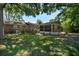 Backyard featuring a screened-in porch, mature trees, and a well-maintained lawn at 1308 Coleridge St, Charleston, SC 29407