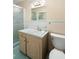 Bathroom featuring a glass door shower, vintage style vanity and bright blue tile at 1308 Coleridge St, Charleston, SC 29407