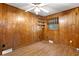 Bedroom featuring wood paneled walls, hardwood floors, a window, and accent lighting at 1308 Coleridge St, Charleston, SC 29407