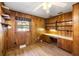 Bedroom featuring wood paneled walls, hardwood floors, a window, and built-in shelving at 1308 Coleridge St, Charleston, SC 29407