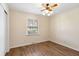Bedroom featuring hardwood floors, a window, and a ceiling fan with a decorative light fixture at 1308 Coleridge St, Charleston, SC 29407