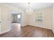 Inviting dining room featuring wood floors and a modern chandelier, creating an ideal space for Gathering gatherings at 1308 Coleridge St, Charleston, SC 29407