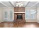 A fireplace with glass doors and shuttered windows, creating a cozy and inviting atmosphere in the living area at 1308 Coleridge St, Charleston, SC 29407