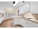 Charming kitchen with white cabinets, an island, and breakfast nook with lots of windows at 1308 Coleridge St, Charleston, SC 29407