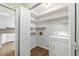 Laundry room with washer, dryer, and shelving, adjacent to the kitchen at 1308 Coleridge St, Charleston, SC 29407