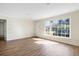 Sunlit living room showcases wood floors and a large window, providing ample natural light, and inviting ambiance at 1308 Coleridge St, Charleston, SC 29407