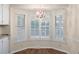 Sun-filled nook with a hanging light fixture and lots of windows with white shutters at 1308 Coleridge St, Charleston, SC 29407