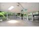 Well-lit sunroom with a ceiling fan, skylights, and views of the backyard at 1308 Coleridge St, Charleston, SC 29407