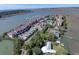 Aerial view of waterfront condos, a boat dock, and scenic marshlands with waterways at 134 Marsh View Villas, Folly Beach, SC 29439