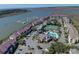 An aerial view of condos near a marina, tennis courts, pool and waterway at 134 Marsh View Villas, Folly Beach, SC 29439