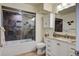 Bathroom with granite countertop vanity and stylish tile and glass shower at 134 Marsh View Villas, Folly Beach, SC 29439