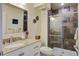 Stylish bathroom with granite countertop vanity and modern tile shower with glass doors at 134 Marsh View Villas, Folly Beach, SC 29439