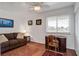 Cozy bedroom featuring a ceiling fan, wood floors, and a desk with ample natural light from the window at 134 Marsh View Villas, Folly Beach, SC 29439