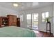 Bright bedroom with a ceiling fan, an outside patio and comfortable furniture at 134 Marsh View Villas, Folly Beach, SC 29439
