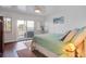 Bright bedroom with a ceiling fan, an outside patio and a comfortable bed at 134 Marsh View Villas, Folly Beach, SC 29439